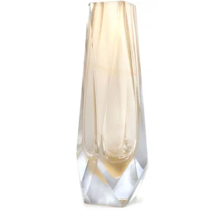 The image showcases a beautifully crafted Murano glass vase. The vase is tall and slender, featuring an elegant design with what appears to be layers or ridges that create a textured effect along its length. It has a light color palette, predominantly in shades of gold and clear, which suggests it could be made from a type of glass known as "aureto" or "golden" glass, a signature technique of Murano glassmaking. The background is plain with subtle gradient tones that complement the colors of the vase without overpowering it, allowing the viewer to focus on the intricate details and craftsmanship of the glass piece. The image likely aims to highlight the vase's beauty and artistry, which are characteristics of Murano glass known for their delicate patterns, skillful shaping, and rich history from Venice, Italy.